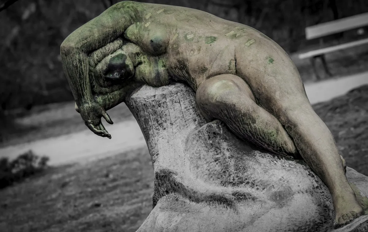 Close-up of a weathered reclining stone statue